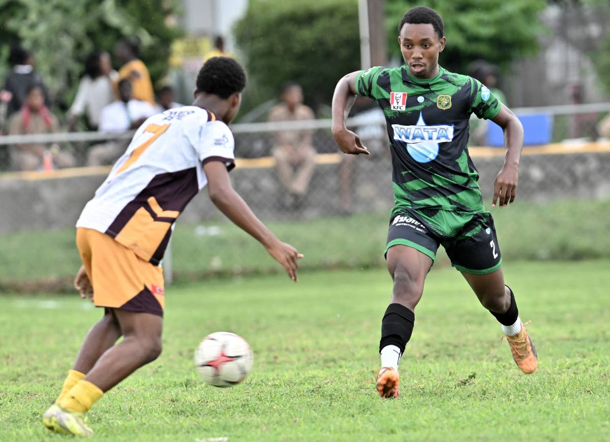 Calabar High School’s Jemario Hanson (right) takes on Wolmer’s Boys’ School’s Kishawn Lewis in an ISSA/WATA Manning Cup game on October 7.