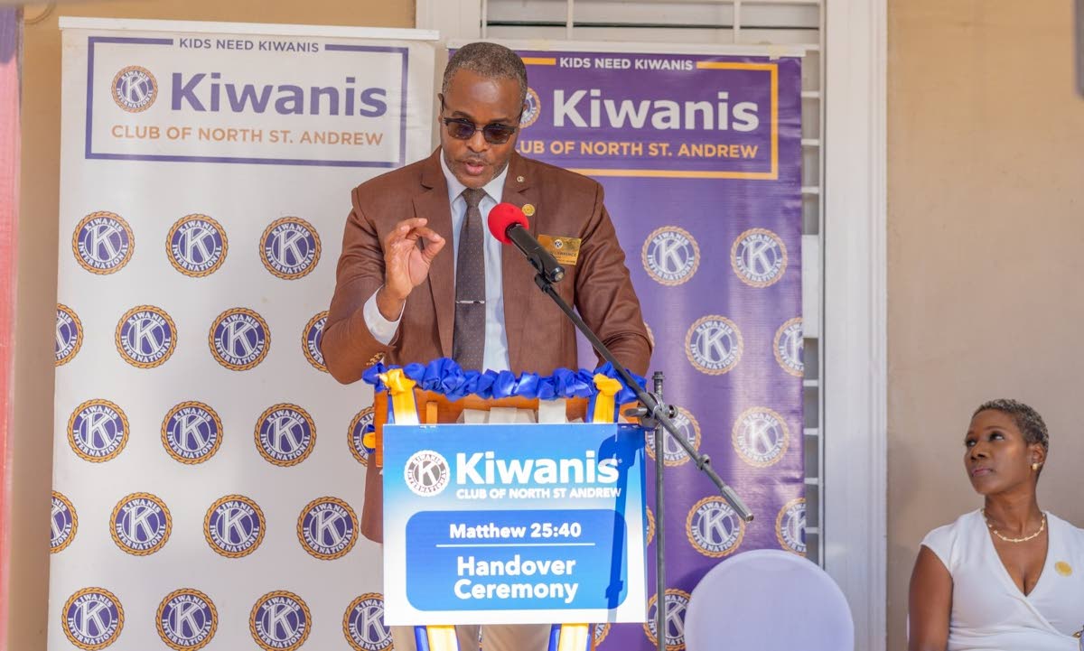 Damion Lawrence, president of the Kiwanis Club of North St Andrew, addresses attendees at the handover of the transitional hostel at Matthew 25:40 Boys’ Home on Tuesday. Looking on is Sharon Williams-Smith, Governor Elect of the Eastern Canada & Caribbea