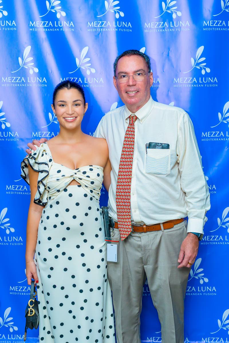 Daryl Vaz, minister of science, energy, telecommunications and transport, poses with his daughter Victoria.