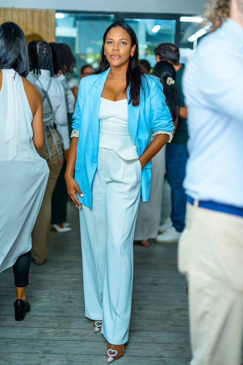 Wardrobe Stylist and Fashion Designer, Kaysian Wilson, exudes effortless style in a baby blue linen jacket and matching pants from her collection, flowerchild1999. 