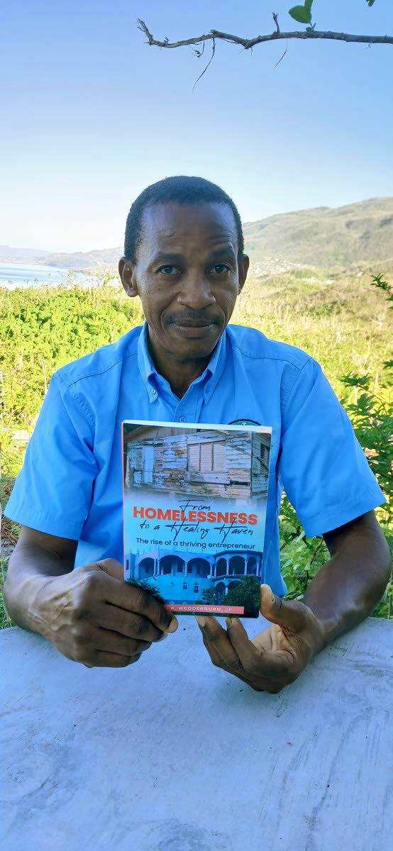 Keith R. Wedderburn displaying his first book.