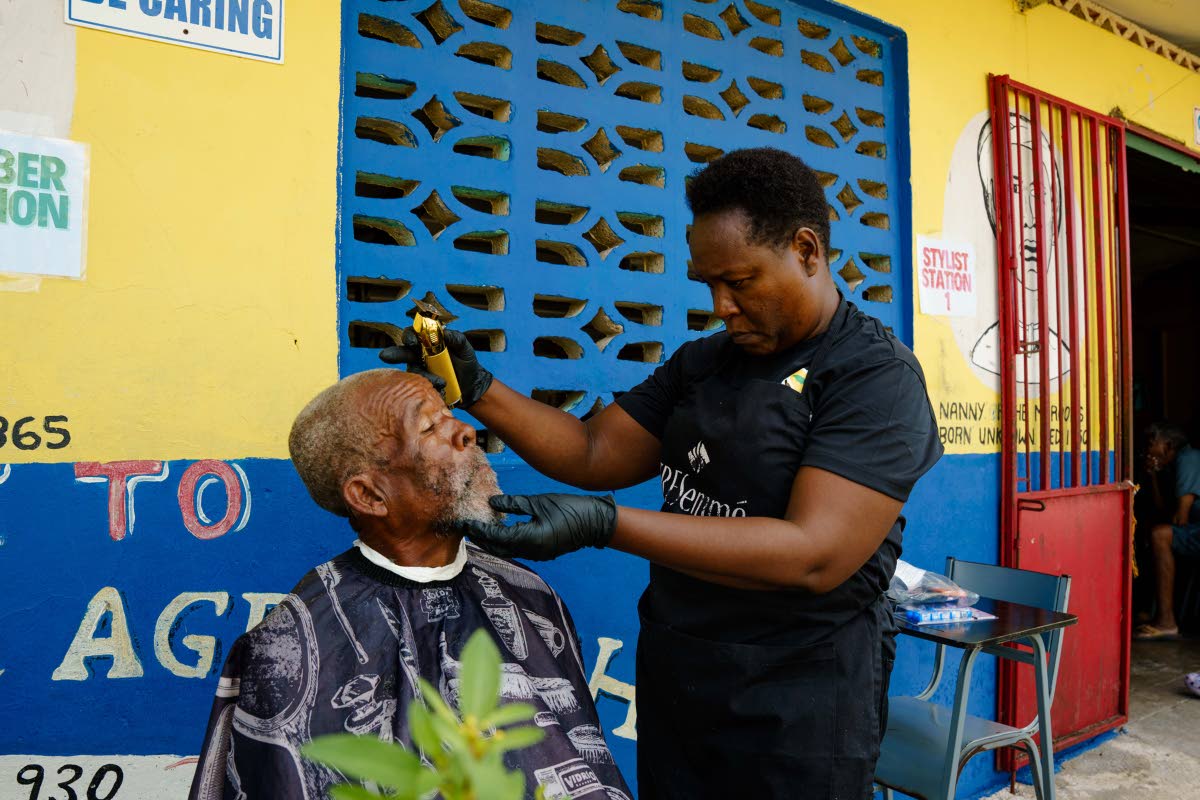 left: A United4GoodJA volunteer gives a shelter resident a trim and shave.