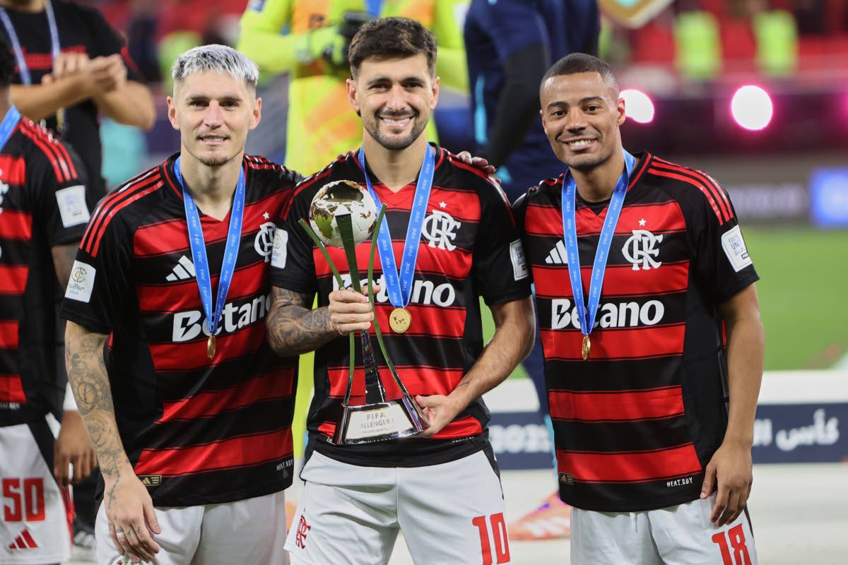 Flamengo's Giorgian de Arrascaeta (centre), Nicolas de la Cruz (right), and Flamengo's Ayrton Lucas pose for a photograph with the trophy after winning the FIFA Intercontinental Cup football match against Pyramids in Doha, Qatar on Saturday.
