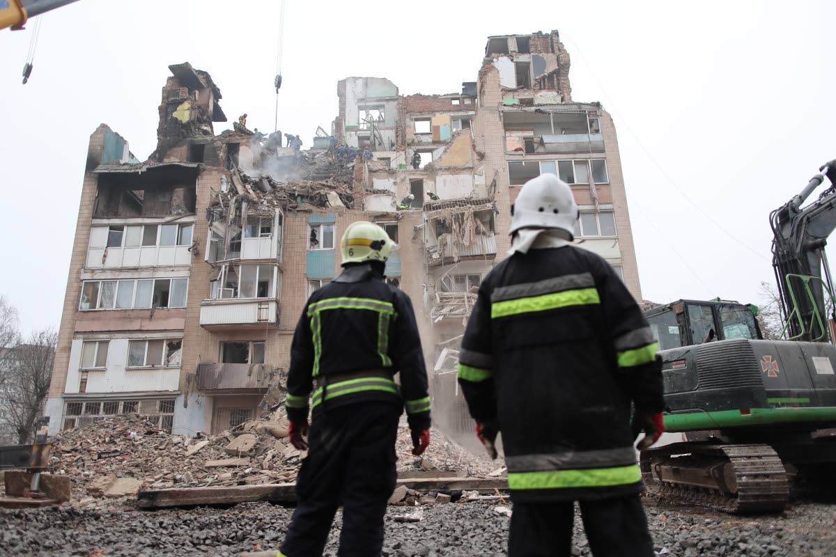 Rescue workers clear the rubble of a residential building which was heavily damaged by a Russian strike on Ternopil, Ukraine, Friday, November 21, 2025. 