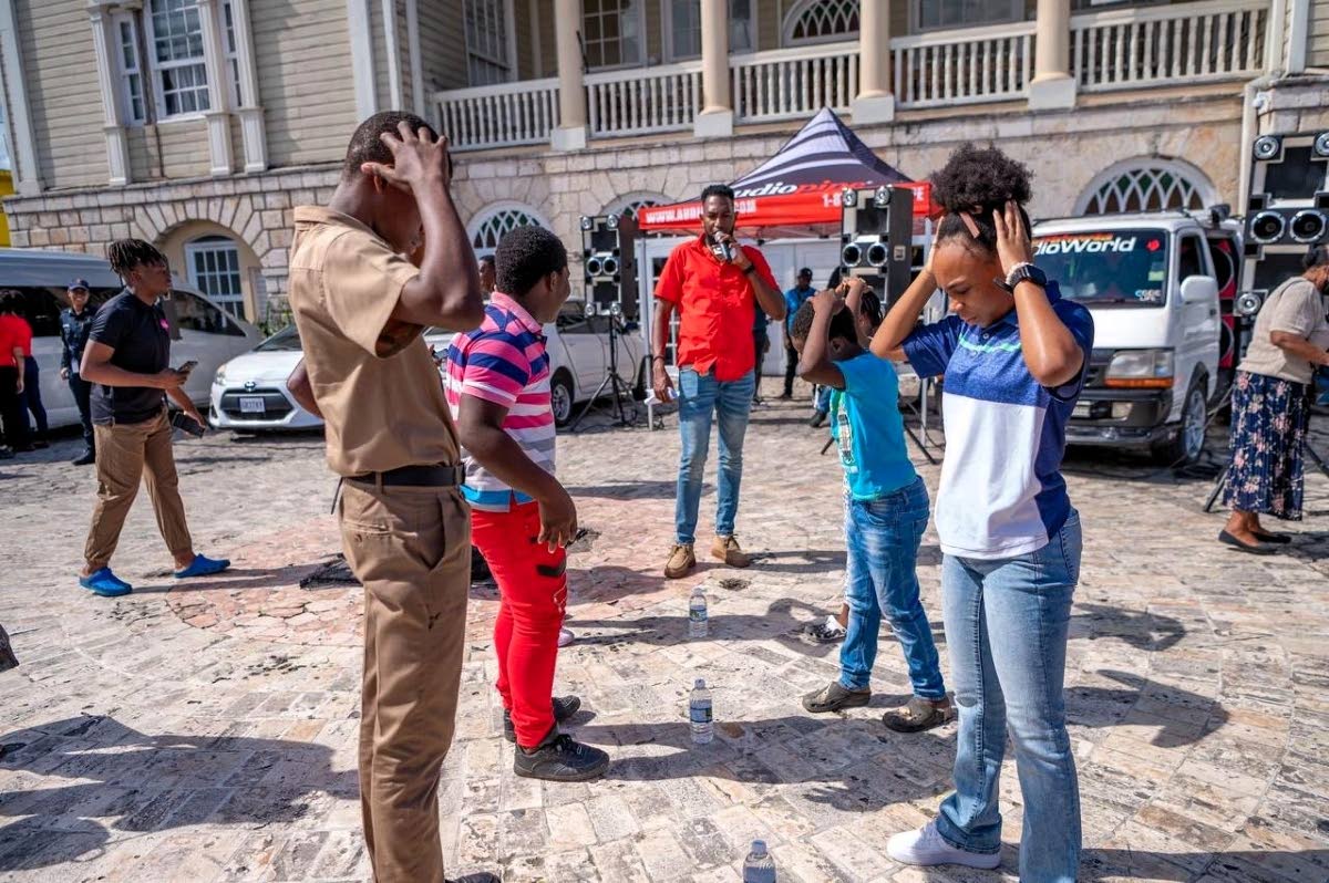 People engage with JN+ staff members during their health camp at Sam Sharpe Square in Montego Bay.
