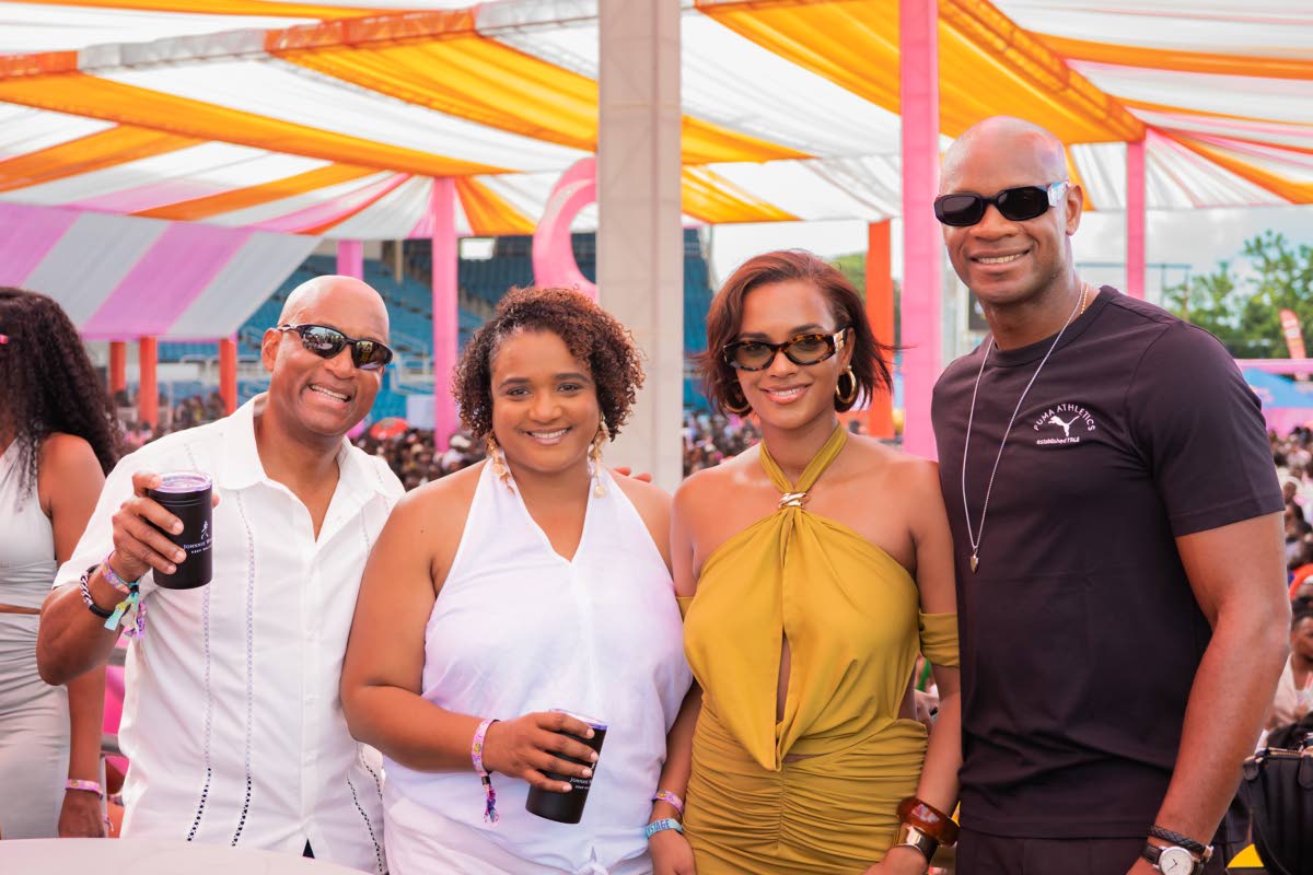 Sprint icon Asafa Powell (right) and his wife Alyshia (second right) share lens with Red Stripe Head of Commerce Sean Wallace (left) and Johnnie Walker Brand Manager Nadine Hylton.