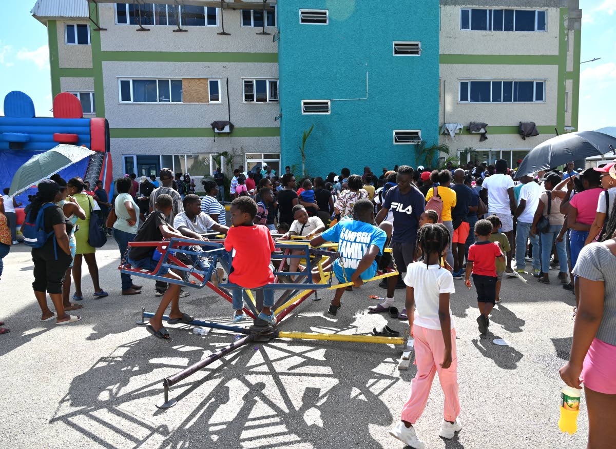 Scores of residents of the Catherine Hall and West Green communities come out during the Montego Bay Free Zone and Global Services Association Jamaica post Hurricane Melissa Christmas Treat on Saturday.