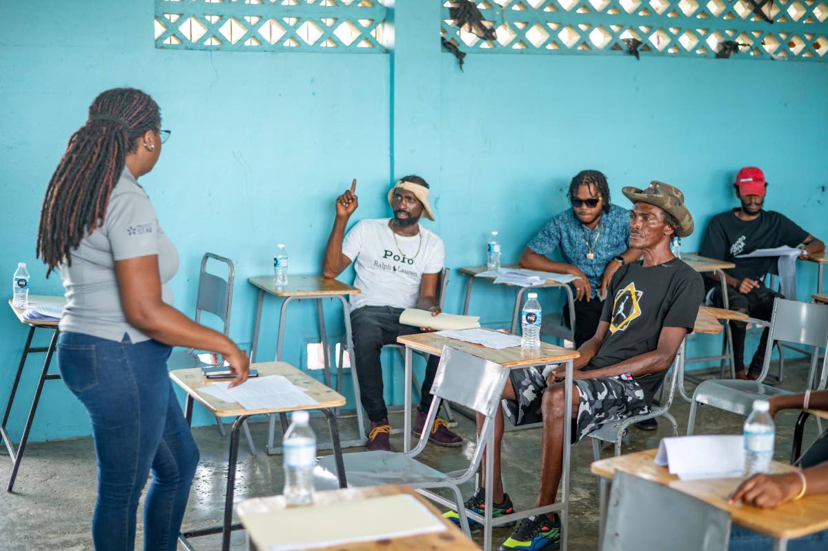 Kelly Griffith, training coordinator  at Project STAR, leads an interactive training session as participants engage in discussion during the Project STAR, UNDP Cash for Care & Work Initiative in Savanna-la-Mar, Westmoreland.