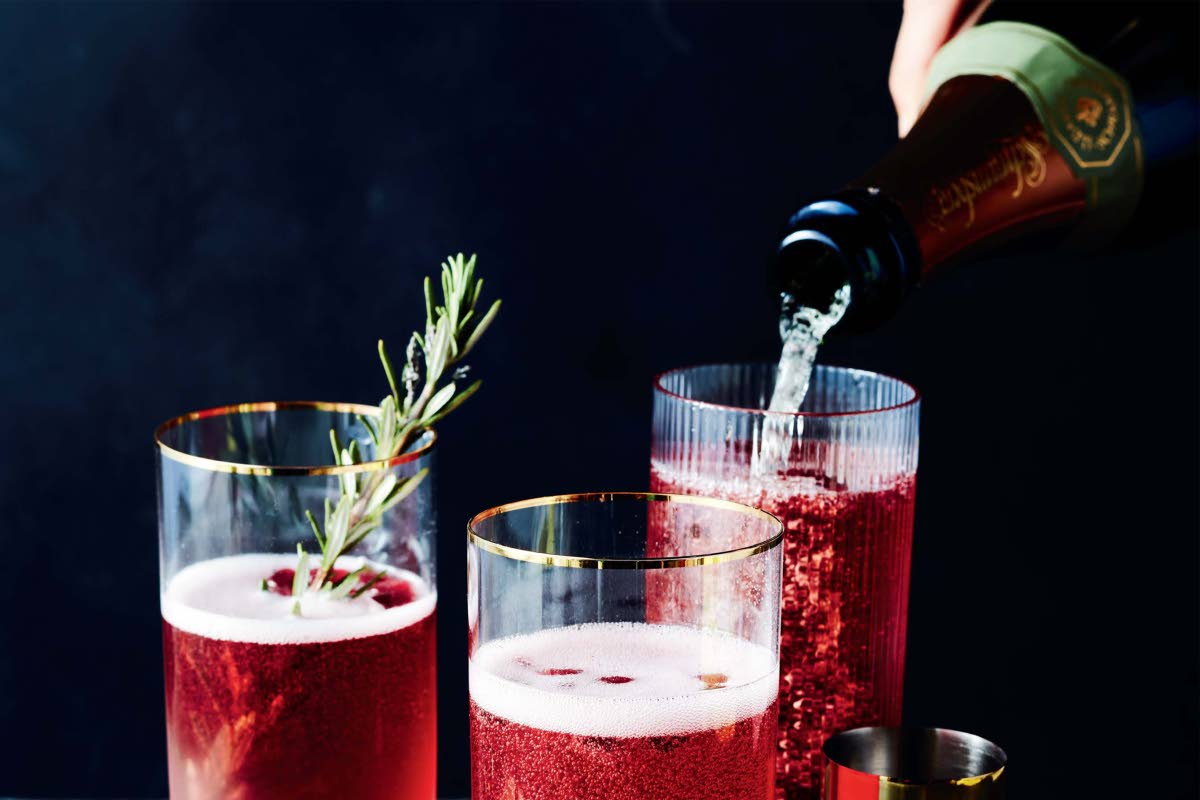 This image released by Voracious shows a recipe for a Champagne cocktail made with pomegranate juice, from the cookbook 'The Full Plate: Flavor-Filled, Easy Recipes for Families with No Time and a Lot to Do' by Ayesha Curry. 