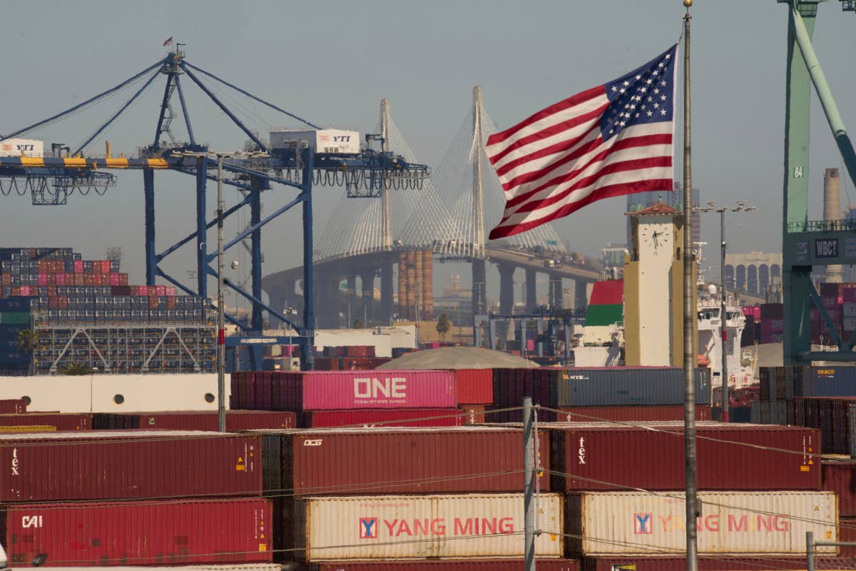 Containers with Yang Ming Marine Transport Corporation, a Taiwanese container shipping company, are stacked up at the Port of Los Angeles, with the Long Beach International Gateway Bridge seen in the background, on Wednesday, April 9 in Los Angeles.  AP 