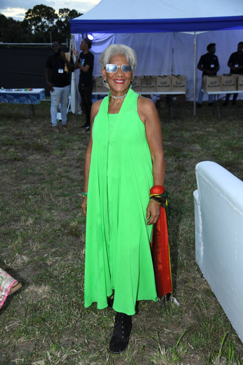 Dressed in lime green, Dr Sherrill Chong, community transformation specialist, brings festive spirit at the An Evening of Light, Music and Giving benefit concert.