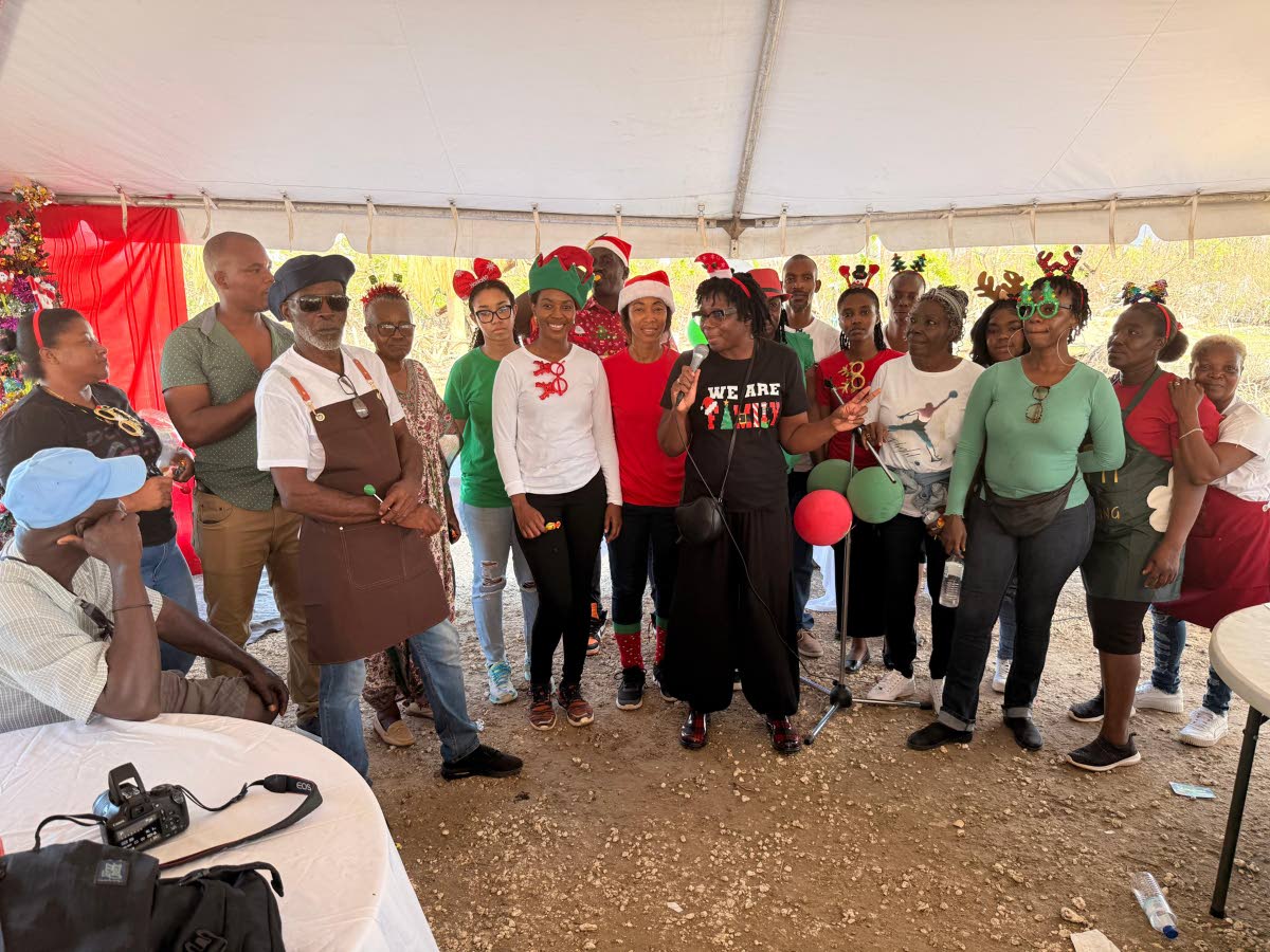 Barrett (front, centre) addresses residents as she is flanked by her team, who helped bring festive meals, gifts, and a day of fellowship while supporting ongoing recovery efforts in Parottee, St Elizabeth.