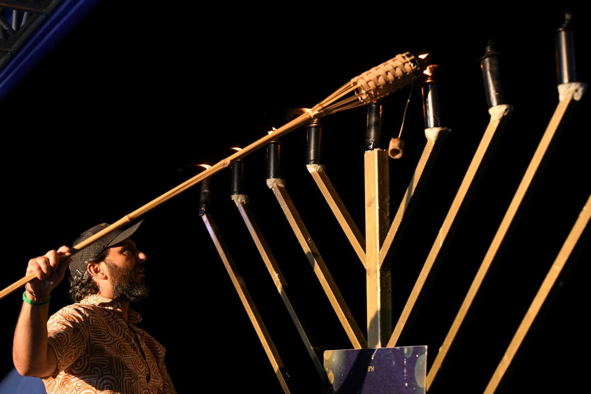 Jesse Lehman ceremoniously lights the candelabra, which burned throughout the night.