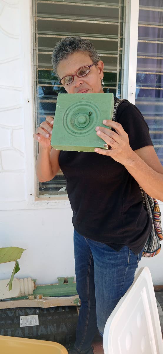 Allison Morris inspecting an object that was among the debris of the St John’s Anglican Church in Black River, St Elizabeth.