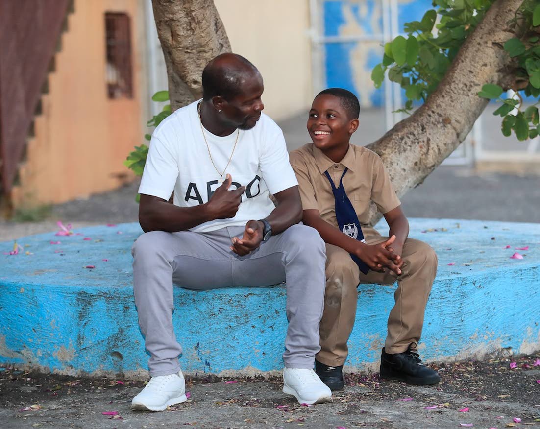 Ricardo Motley shares a warm and proud moment with his son, reflecting the positive impact the Child Resiliency Programme continues to have on families.