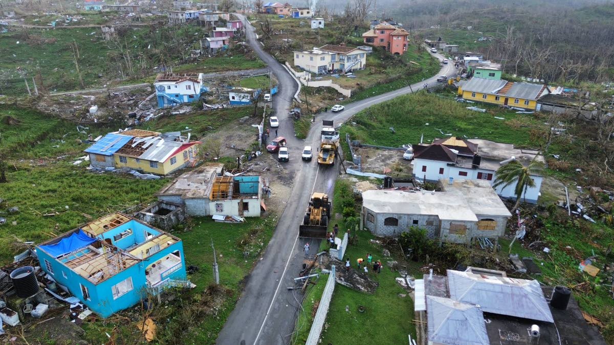 A road is being cleared of debris after the passage of Hurricane Melissa