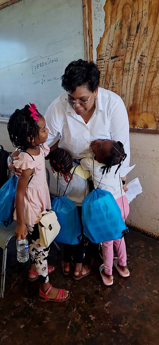 Above: Smith interacting with children who participated in the Bahali Hurricane Recovery Project in St Elizabeth.