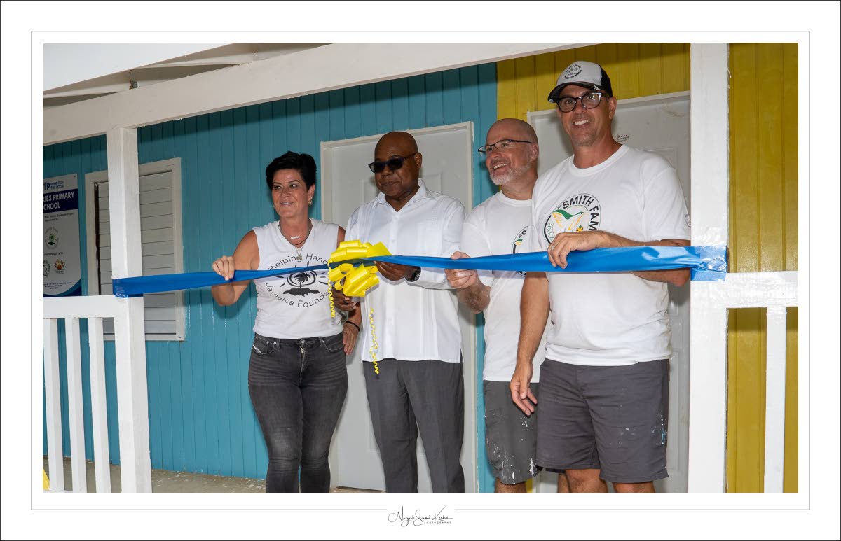 Tourism Minister Edmund Bartlett (second left) cuts the ribbon at the opening of Dumfries Infant and Primary School in St James in 2024 with Natasha Borota (left) and volunteers looking on.