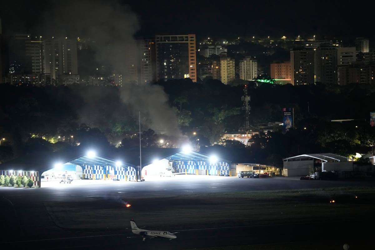 Smoke raises at La Carlota airport after explosions and low-flying aircraft were heard in Caracas, Venezuela, on Saturday.