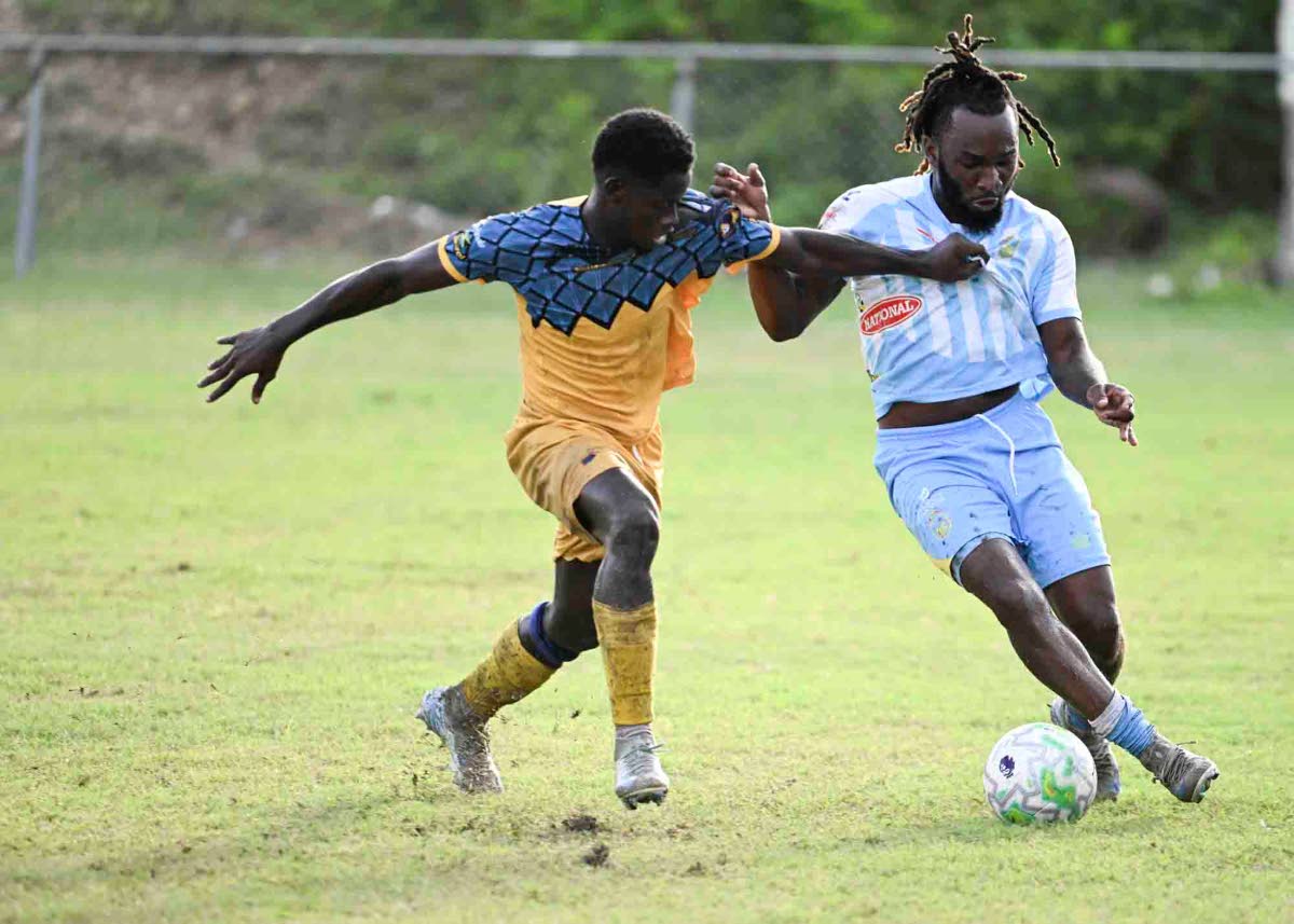 Racing United’s  Heron Headman (left) and Kenley Deacon of Waterhouse battle for the ball during Monday’s Jamaica Premier League match at Ferdi Neita Park. The game ended in a 0-0 draw.