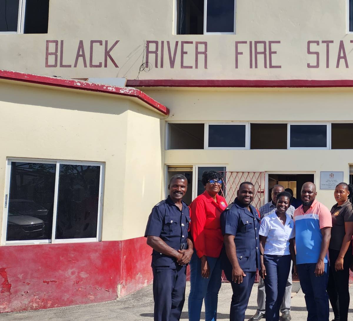 Northern Caribbean University psychologists Dr Grace Kelly (2nd left) and Dr Venese Madden (4th left) with firefighters at the Black River Fire Station.