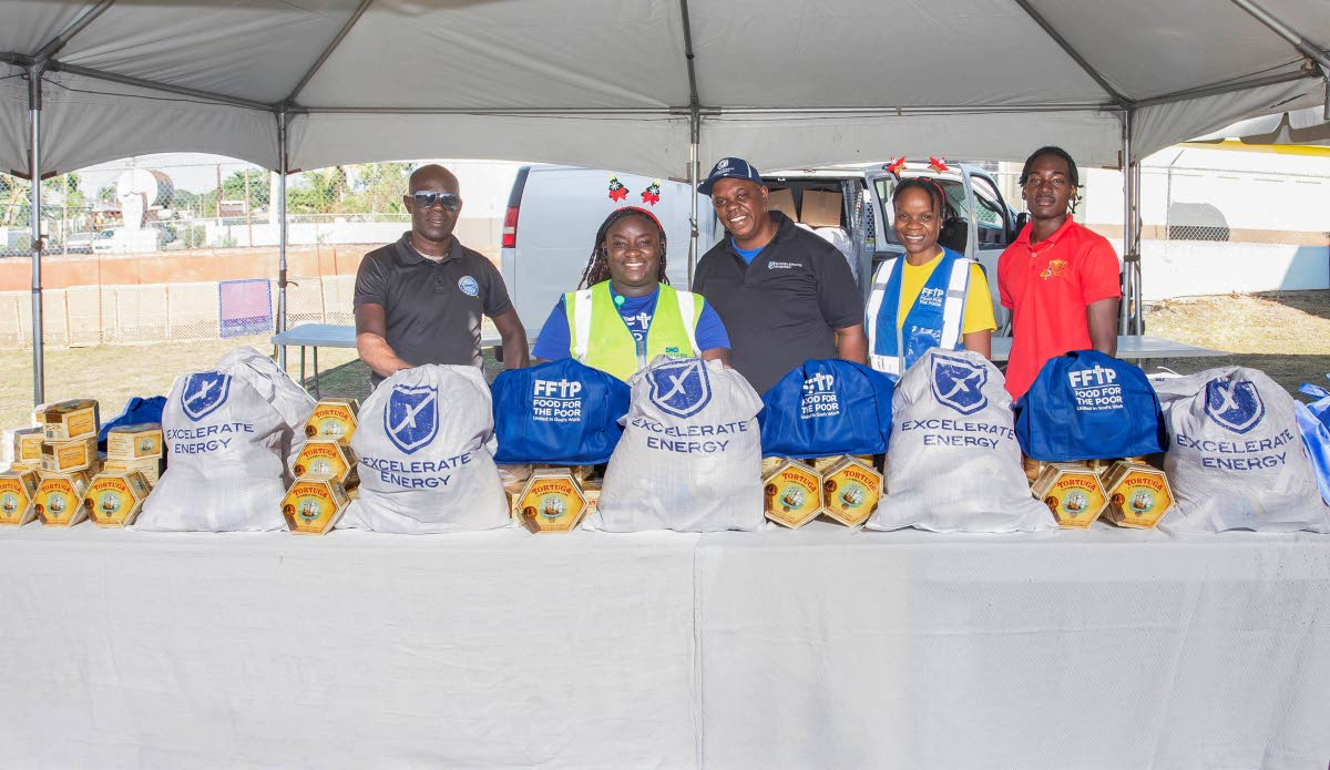 Members of the Food For The Poor Jamaica and Excelerate Energy teams getting ready to distribute food packages to families on the PATH programme in Hayes, Clarendon.