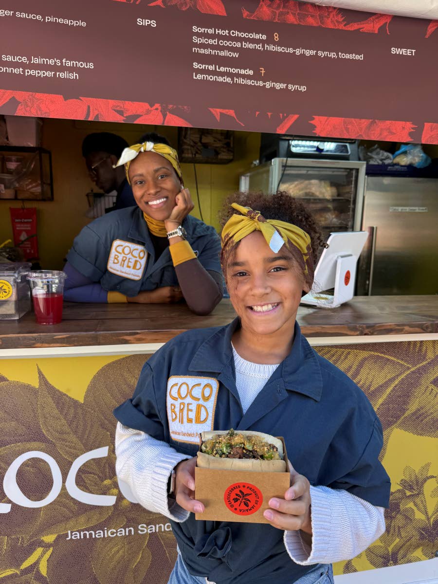 Coco Bread Founder Jaime Randle and her daughter, Ruby, holding the brand’s jerk bird order at the Union Square Holiday Market in New York last month.