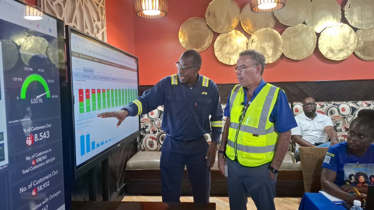 JPS CEO Hugh Grant (left) speaks with Energy Minister Daryl Vaz about post-Hurricane Melissa restoration efforts in the Western Region at their Incident Command Centre at Sandals, Whitehouse in Westmoreland. 