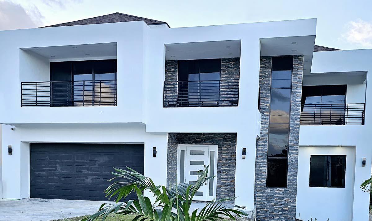 This modern Richmond, St Ann, villa in Plantation Village blends clean lines, open-plan living, and seamless indoor-outdoor flow, creating a serene family escape.