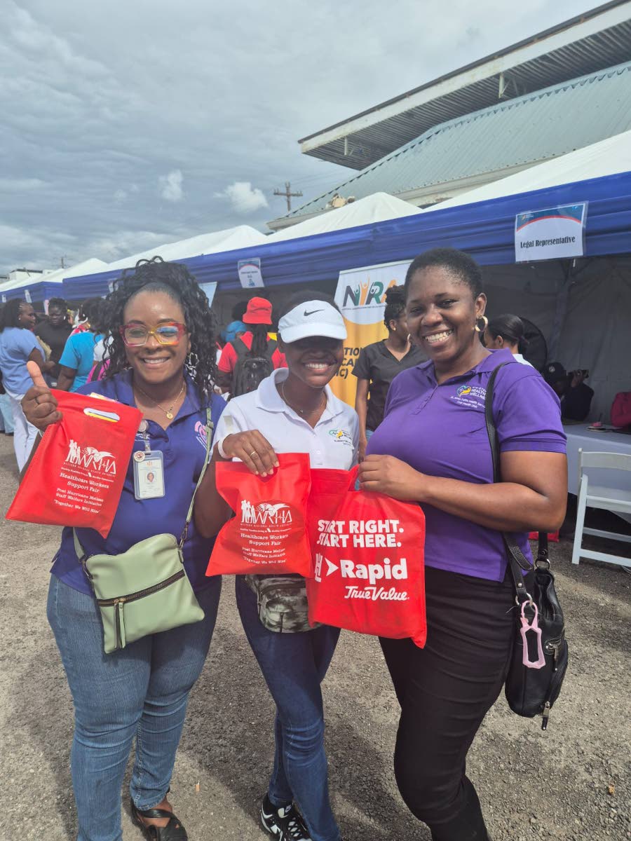 From left: Phyllipia Whyte, Anna-Shai Stennett, and Shelly-Ann Clarke, dental aides at the St James Type V Health Centre in Montego Bay, St James, show off the goodie bags they received during the Western Regional Health Authority’s Healthcare Workers Su