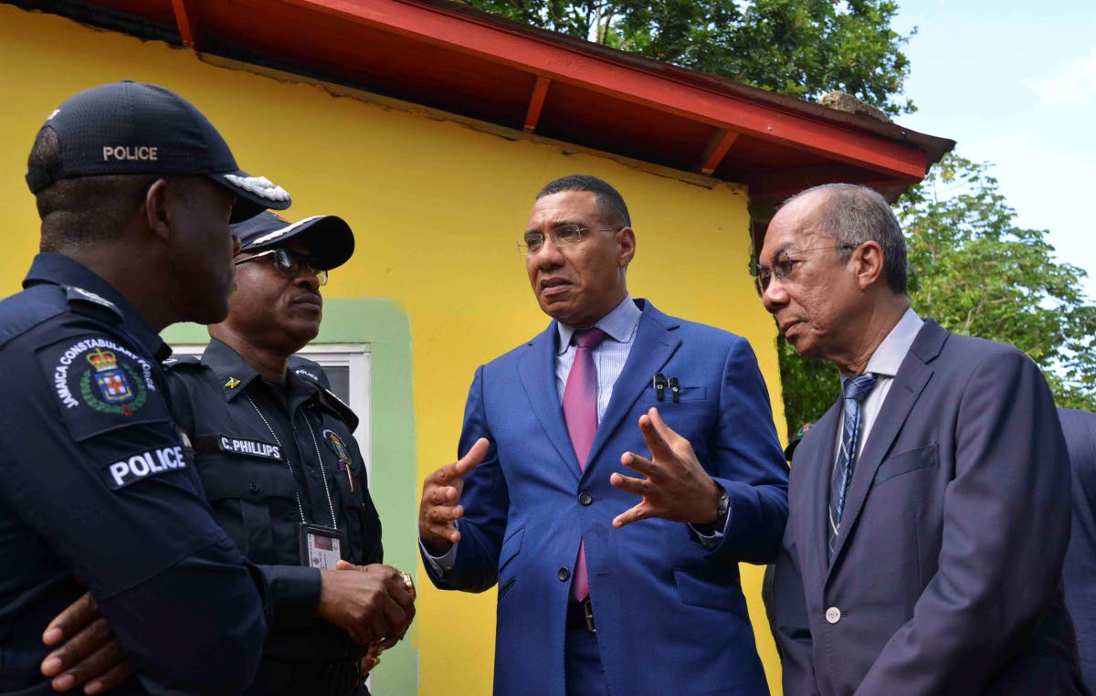 Prime Minister Dr Andrew Holness (second right) in dialogue with Deputy Prime Minister and Minister of National Security, Dr Horace Chang (right), Police Commissioner Dr Kevin Blake (left) and Assistant Commissioner of Police for Area 5,  Christopher Phill