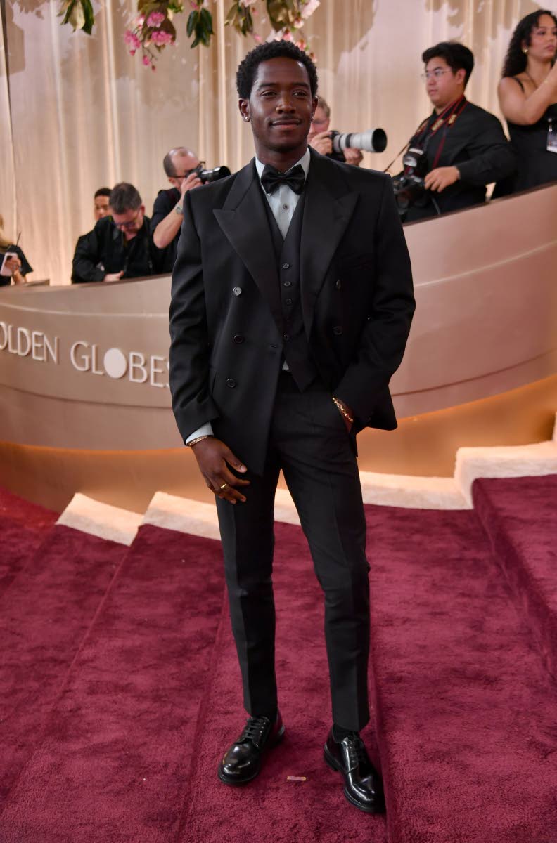 Prada ambassador Damson Idris stuns in a black three-piece tuxedo with a mint poplin shirt and his own Didris jewellery.