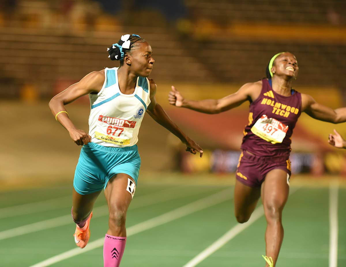 Lacovia High School’s Sabrina Dockery (left) and Holmwood Technical’s Doniellia Lewis competing at the ISSA/GraceKennedy Boys and Girls’ Athletics Championships last year.