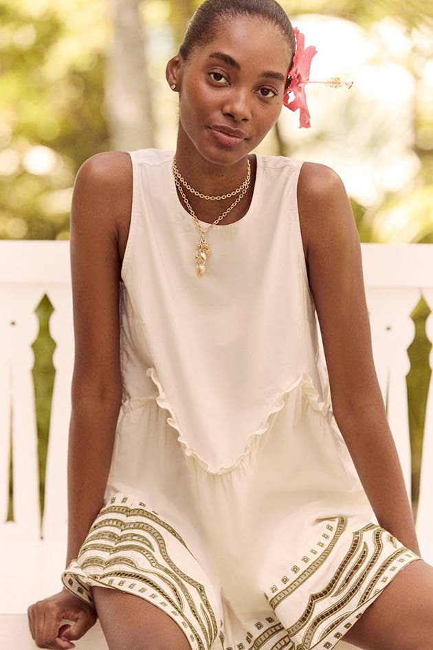 The sage cotton Joyce mini dress with a wavy ruffle waist seam from the just-out Resort 2026 collection lookbook that co-stars SAINT model Tami Williams.