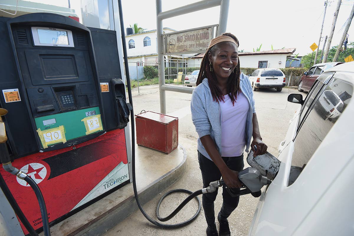 Alesha pumping gas at at Willis Gas Station in Cave Valley, St Ann, last week. She recalled that days after the passage of Hurricane Melissa last October, all she could see was water when she looked down at the town.
