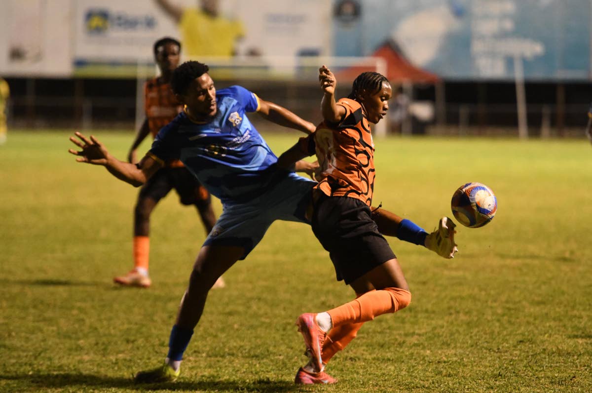 Odane Murray of Molynes United (left) kicks the ball away from Nickalia Fuller of Tivoli Gardens FC during last night’s Jamaica Premier League fixture at the Anthony Spaulding Sports Complex in Kingston. Molynes won 3-2.