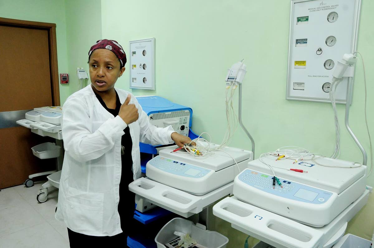 Dr Cleopatra Patterson, paediatric cardiac anaesthetist and intensivist at the Bustamante Hospital for Children, demonstrates the use of a newly donated Electrocardiogram machine.