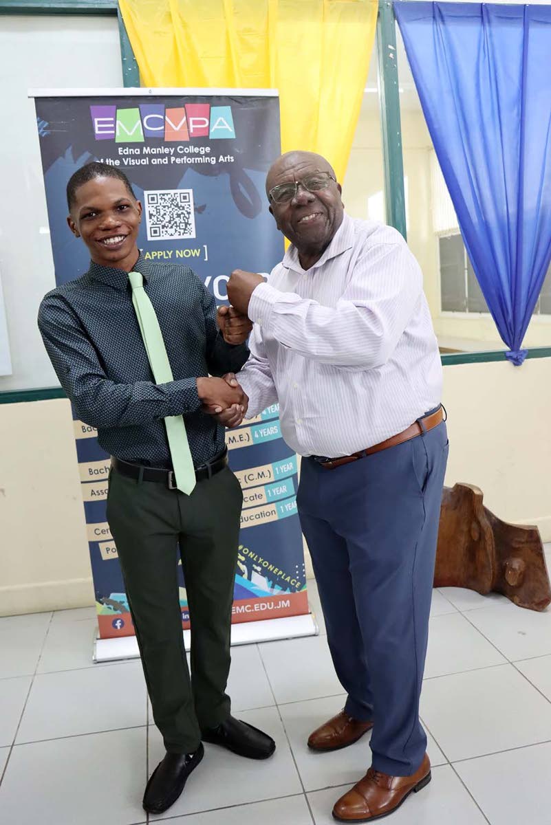 Comedian and cultural icon Oliver Samuels (right) shares a light moment with his foundation’s first scholarship awardee, Dante Saunders, following the handover ceremony.