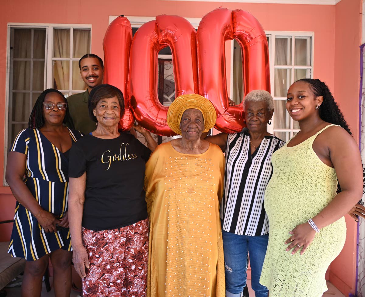 Ethlyn Clarke (centre), of Mt Salem, St James, together with family members and well-wishers on Thursday, following the celebration of her milestone 100th birthday on Tuesday. Also pictured (from left) are Paulette Ricketts, caregiver for Ms Clarke; Tyler 
