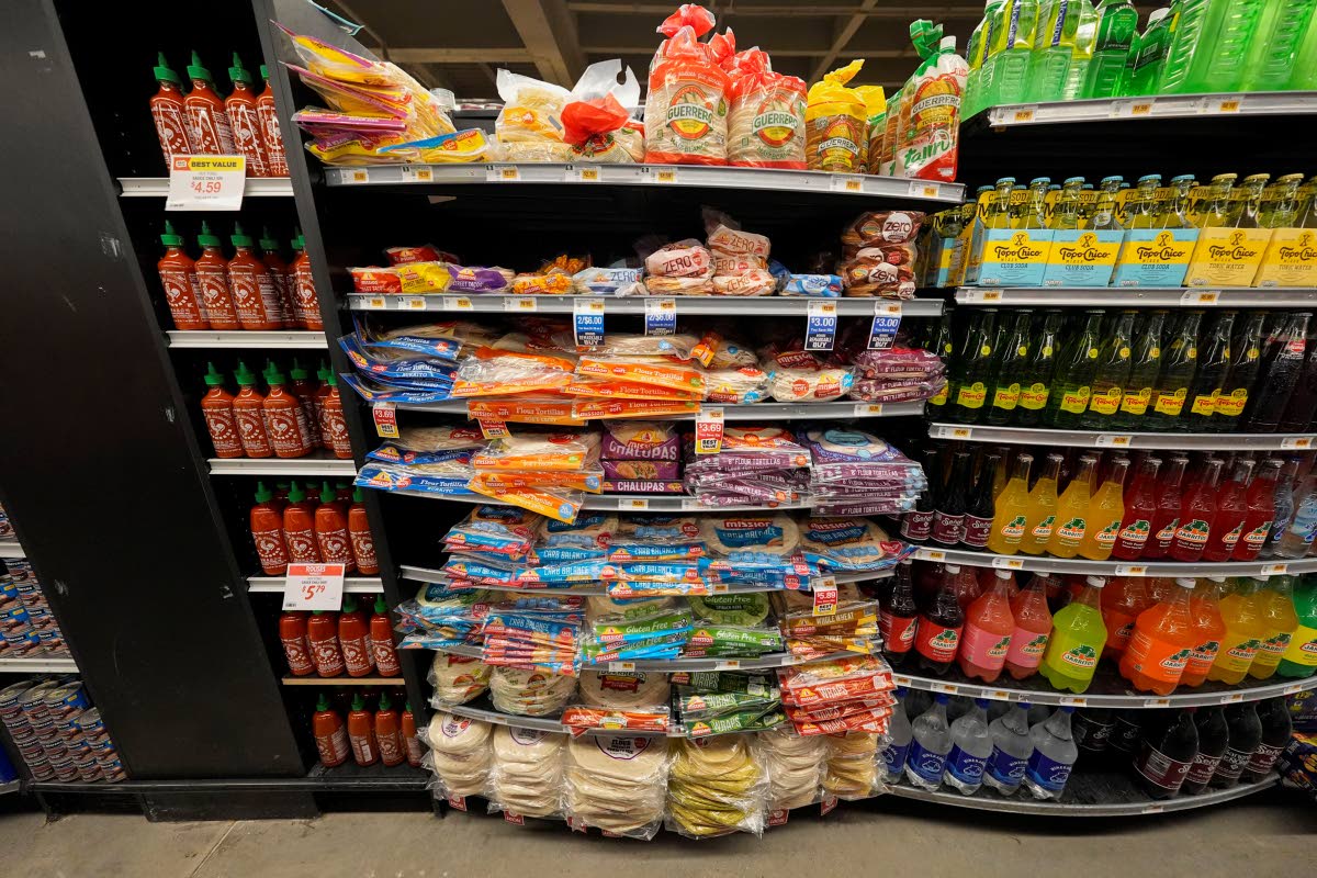 Tortillas in plastic packaging are seen near glass and plastic bottles at a grocery store in New Orleans.