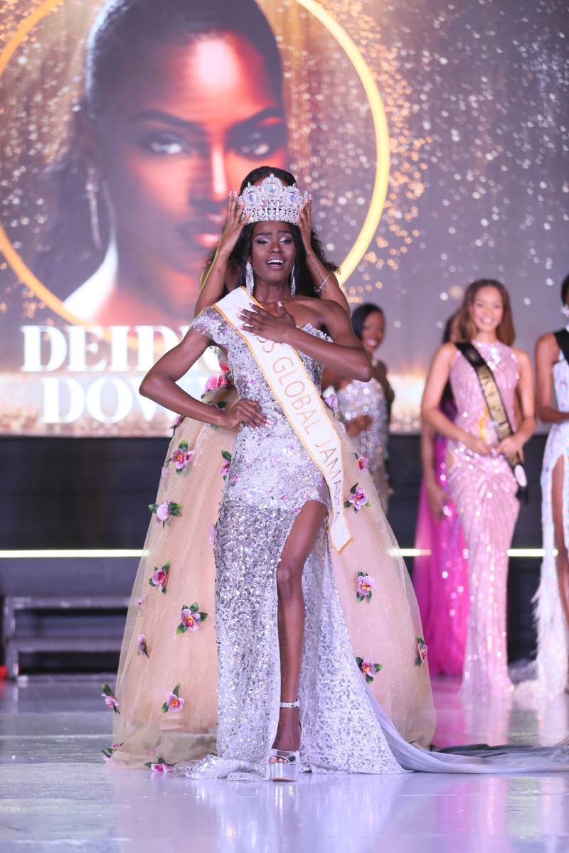 An overwhelmed Deidrian Downer is crowned Miss Global Jamaica 2026 by Keri-Ann Greenwood, Miss Global Jamaica 2025 and first Runner-up Miss Global 2025 during the Grand Coronation on Saturday  at the Douglas Orane Auditorium, Wolmer’s Boys, Kingston