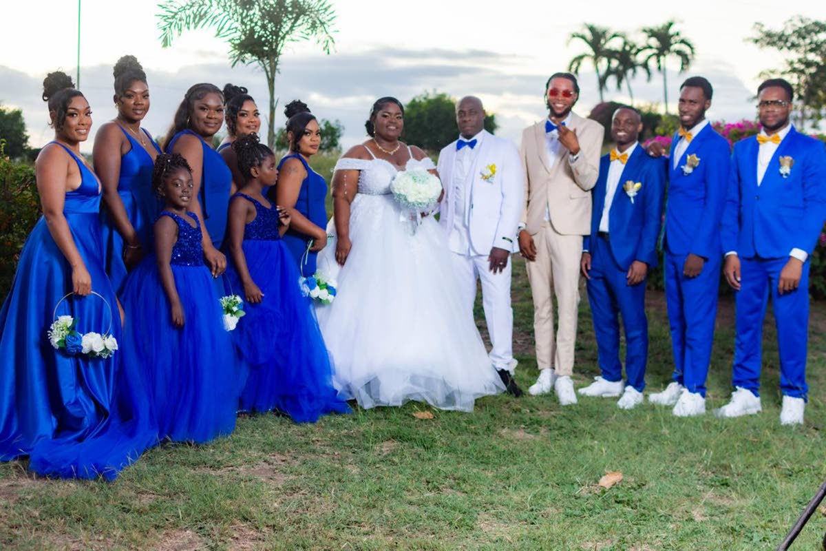 The bride and groom, donned in all white, were happy to be joined by their wedding party, adorned in cobalt blue and a touch of beige for the special occasion.