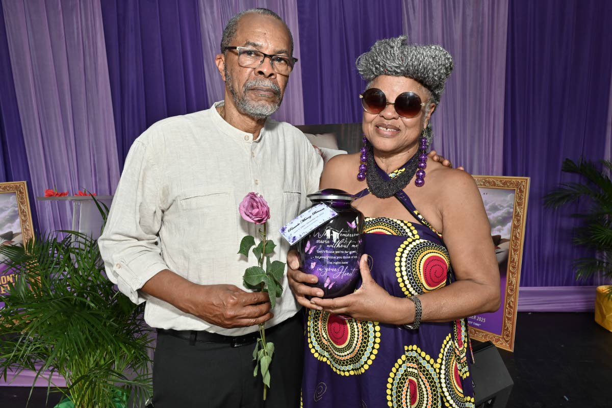 Ricardo Munoz Bennett holds a single rose while Bridgett Anderson cradles the urn at the thanksgiving service for the life of Ricardo Anthony Munoz-Bennett.