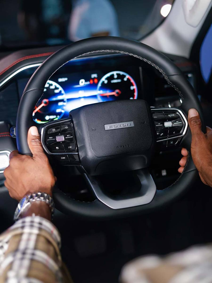 The driver’s perspective inside the Tunland V9, featuring the steering wheel controls and 7-inch, full-colour digital instrument cluster.