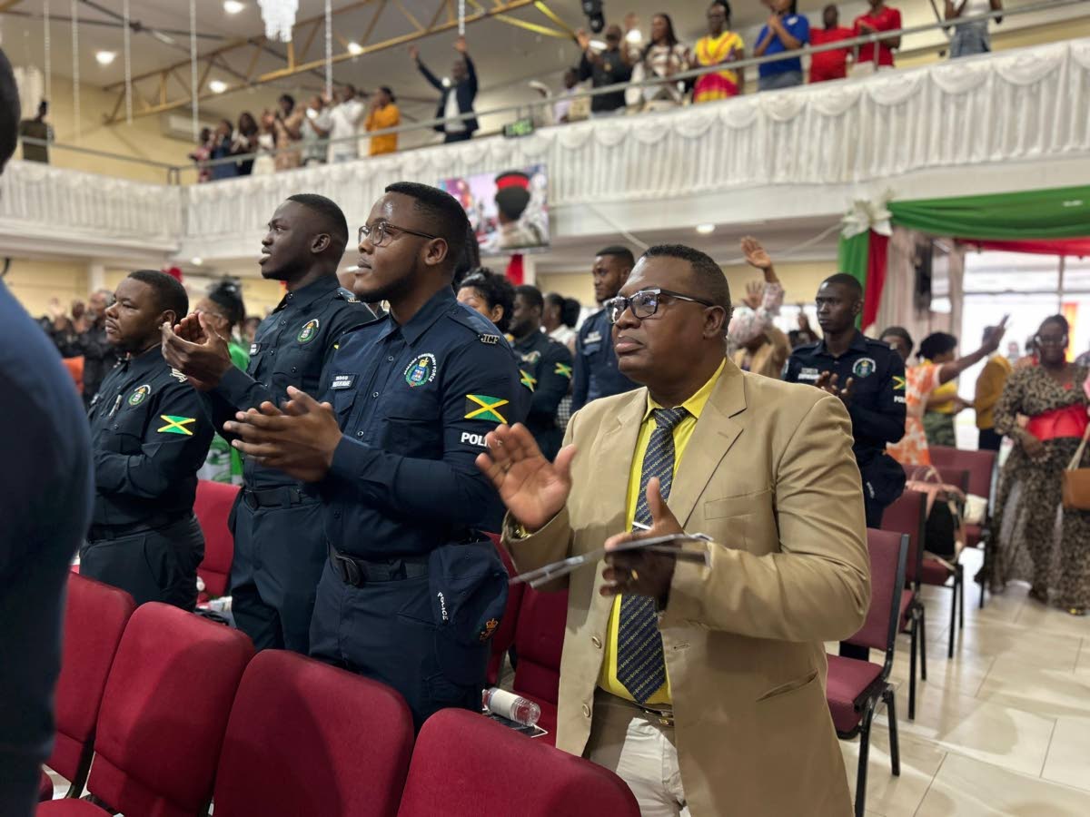 Police personnel along with the congregation in worship. 