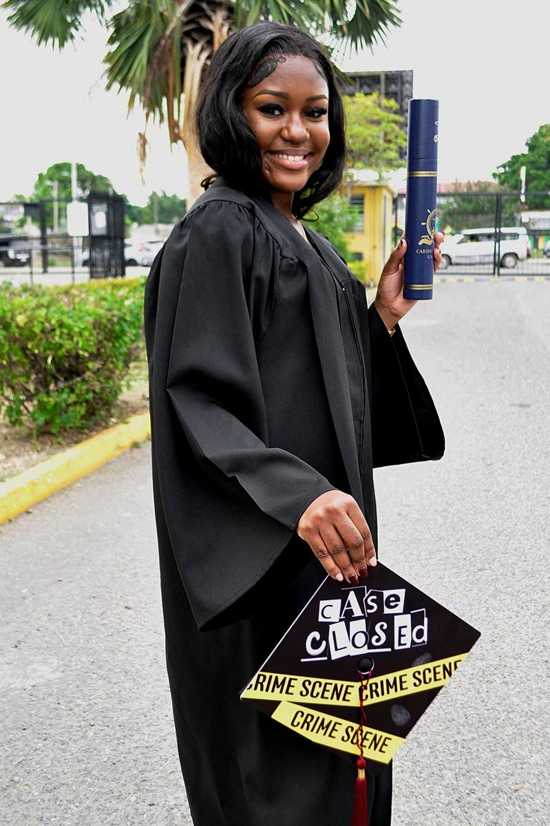 Jamaela Record beams with her Bachelor of Science degree after graduating from the Caribbean Maritime University on Wednesday. 