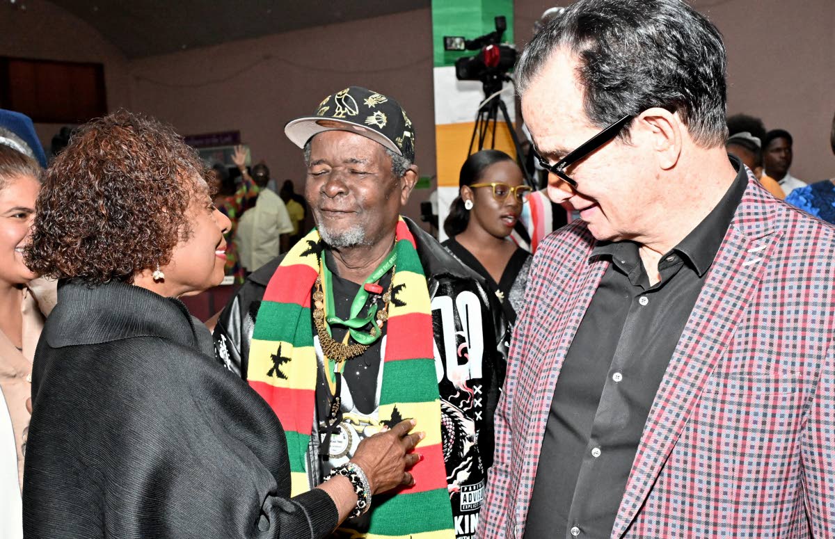 Minister of Culture, Olivia Grange (left) greets Bongo Herman, (centre) and Joe Bogdanovich at the Reggae Month Church Service. 