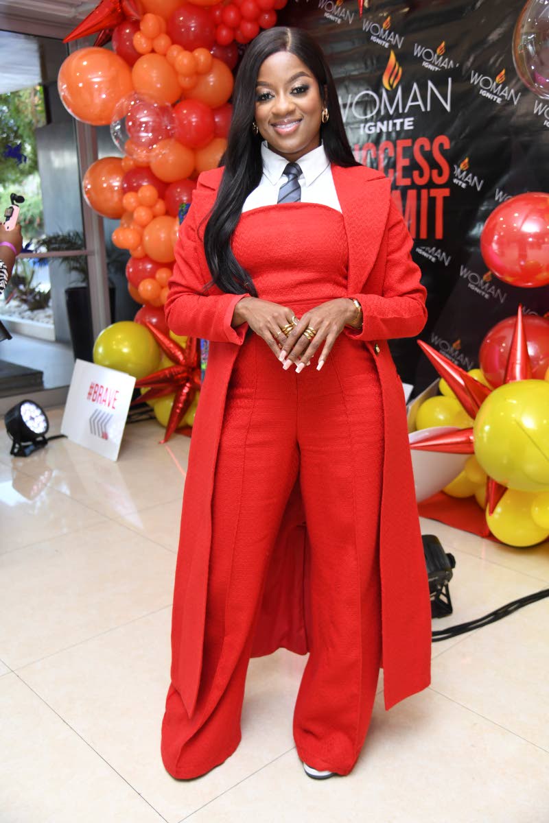 Stylish in red, worship leader Kayann Ledford pairs a jumpsuit with a coat and tie.