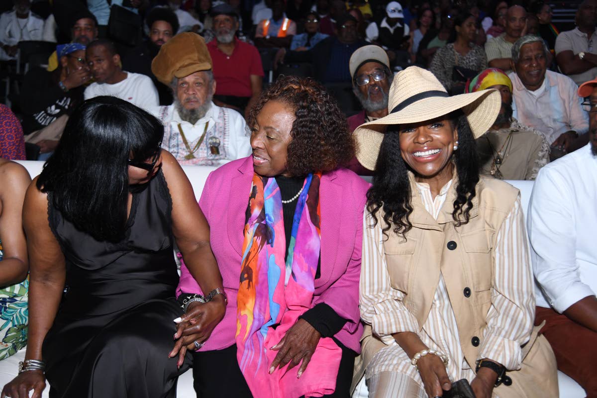 From left: Thelma Dunbar, Minister of Culture Olivia Grange and Sheryl Lee Ralph sit together during the live performances at the nine-night for Sly Dunbar.