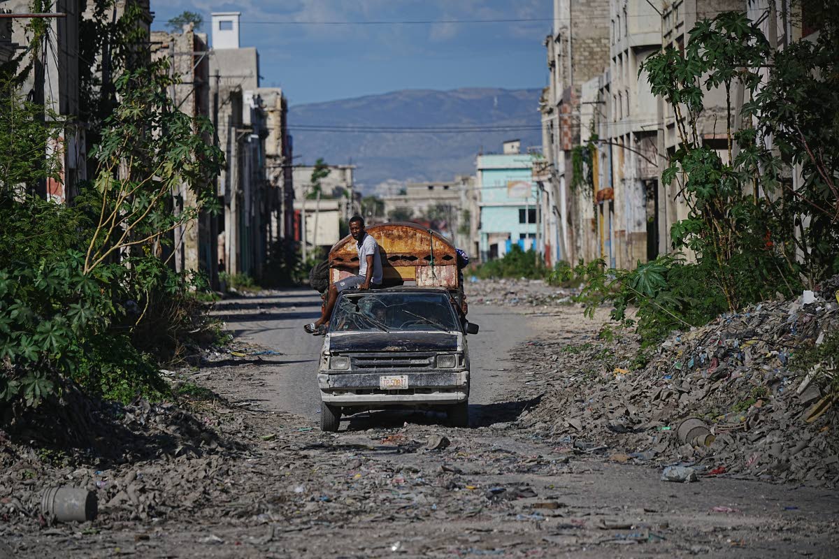 A local travels on public transportation through a gang-controlled area of Port-au-Prince, Haiti.